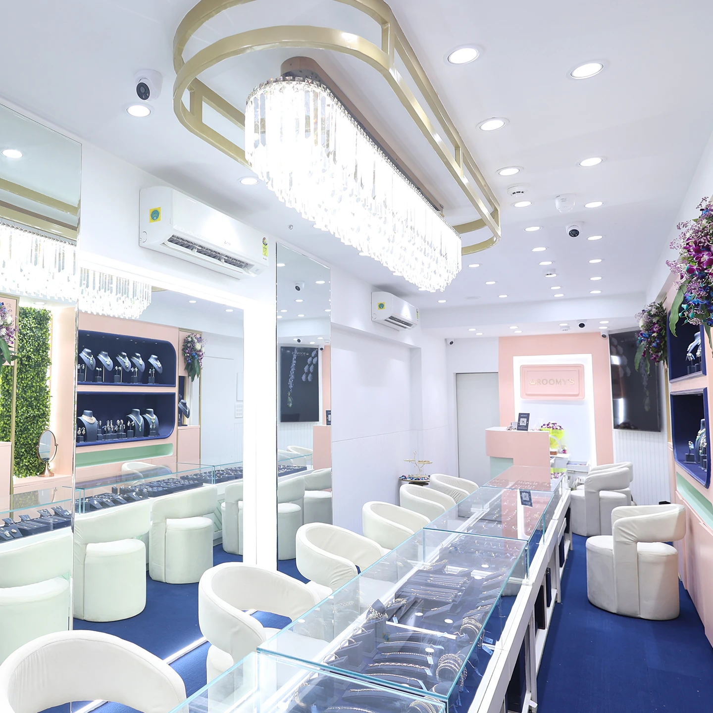 An image of one of our showrooms with floral light fixtures and clear display cases is pictured