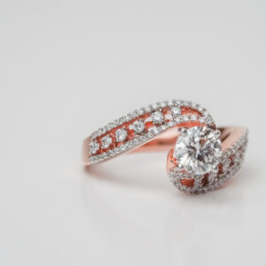 Round Solitaire Engagement Ring with Twisted Bypass Band in Traditional Diamond Setting